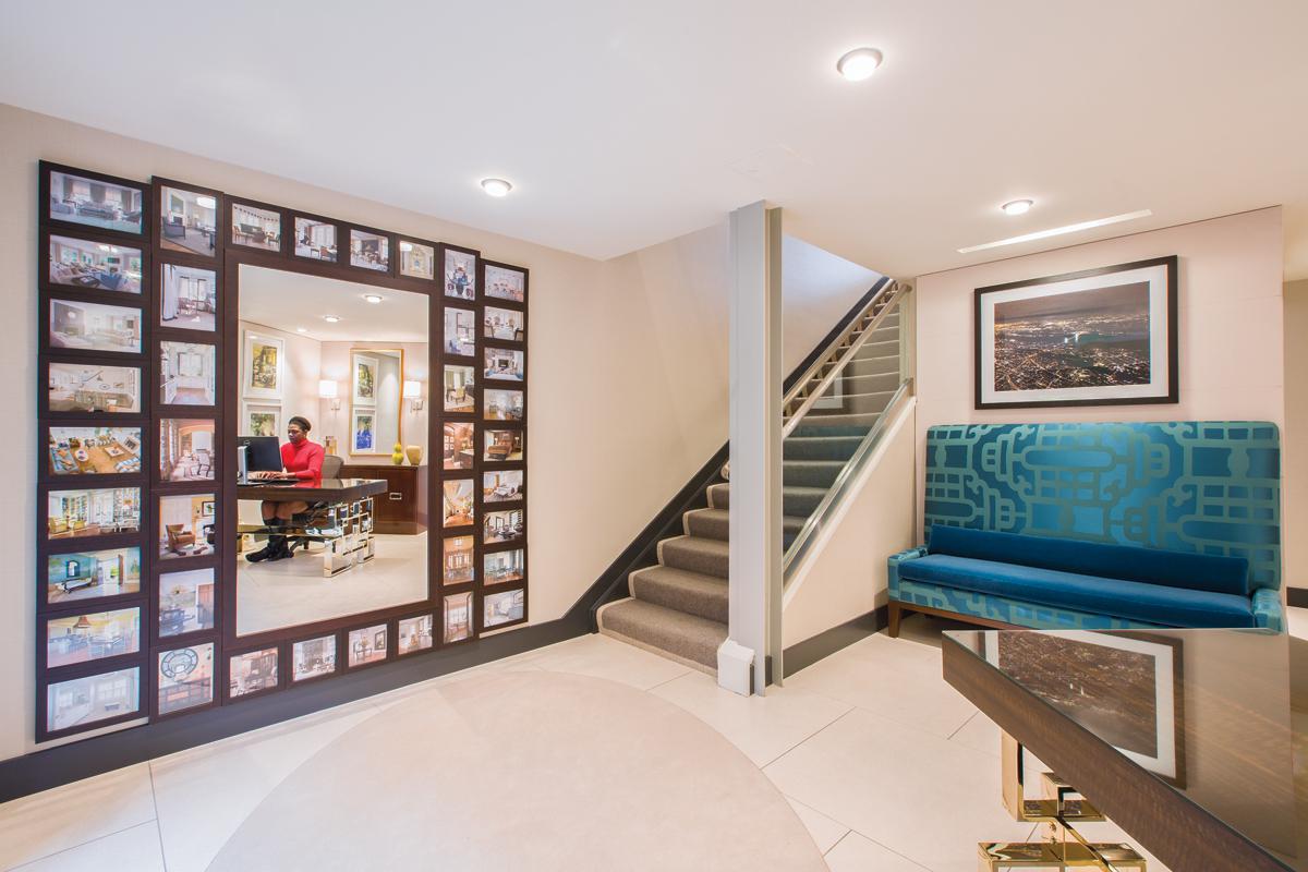 The reception area features a mirror framed by photographs of Sroka’s projects.
