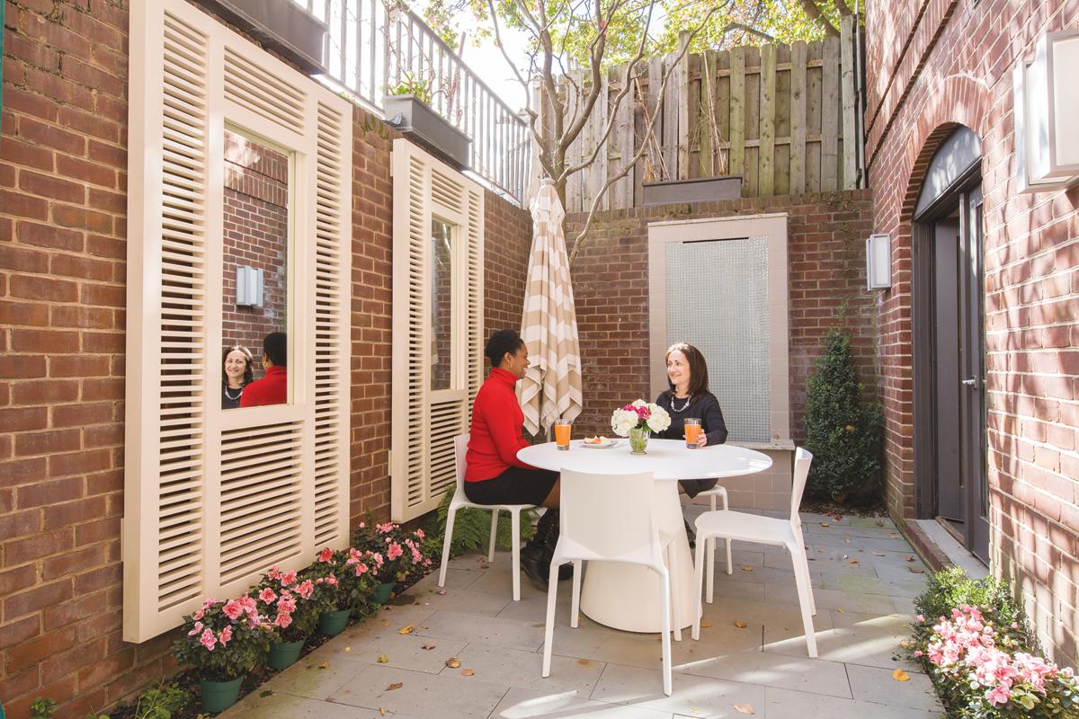 A small, brick-walled courtyard makes a welcome spot for a break.