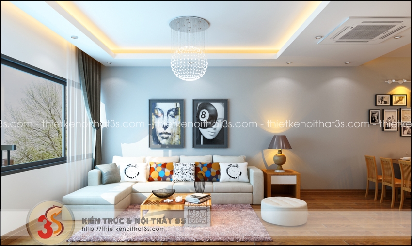 Một chiếc sofa trắng trải dài cùng bộ bàn tiếp khách mini.